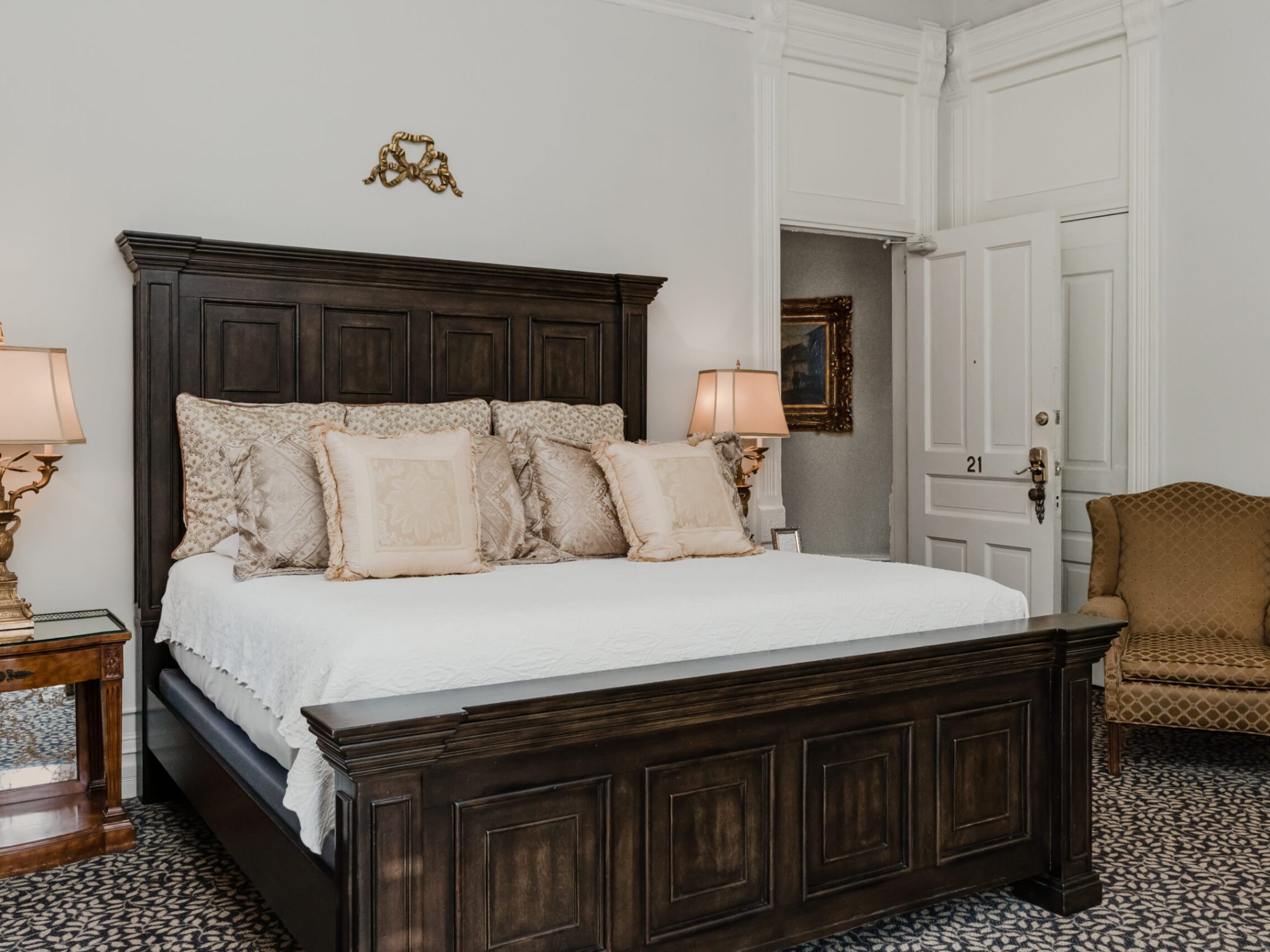 a bedroom with a bed and a chair in a room