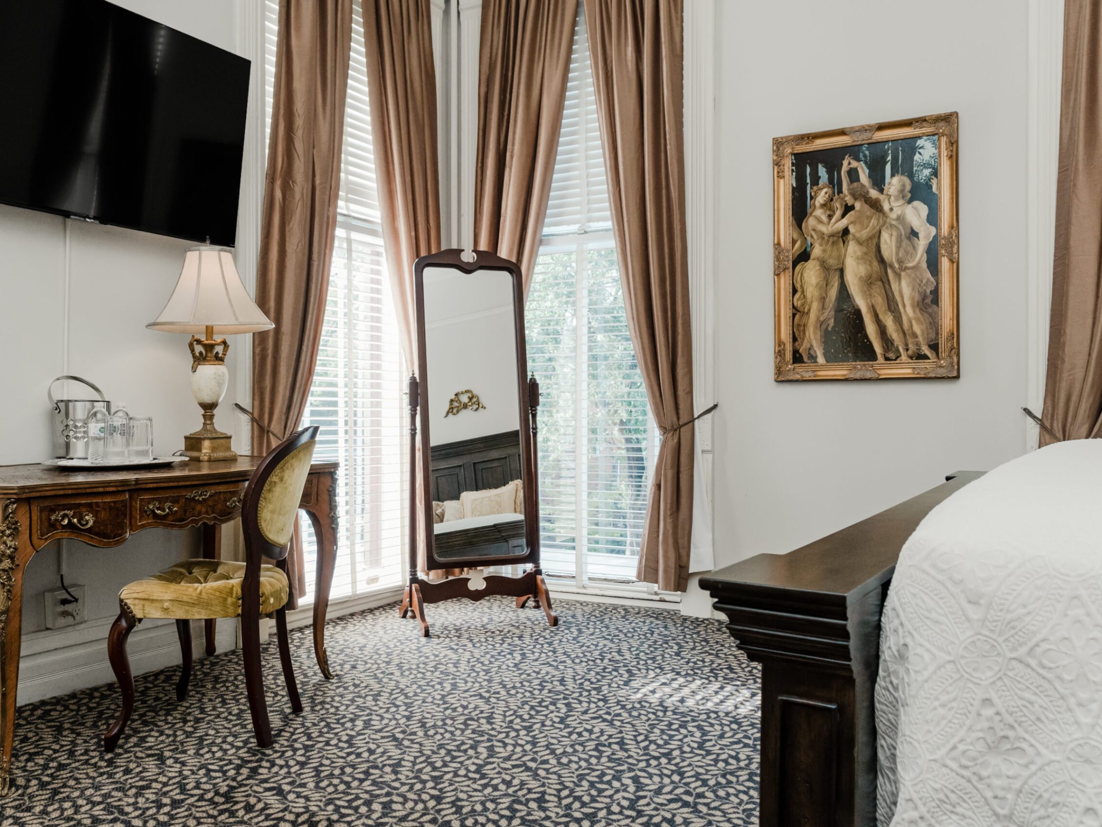 a bedroom with a bed and a chair in a room