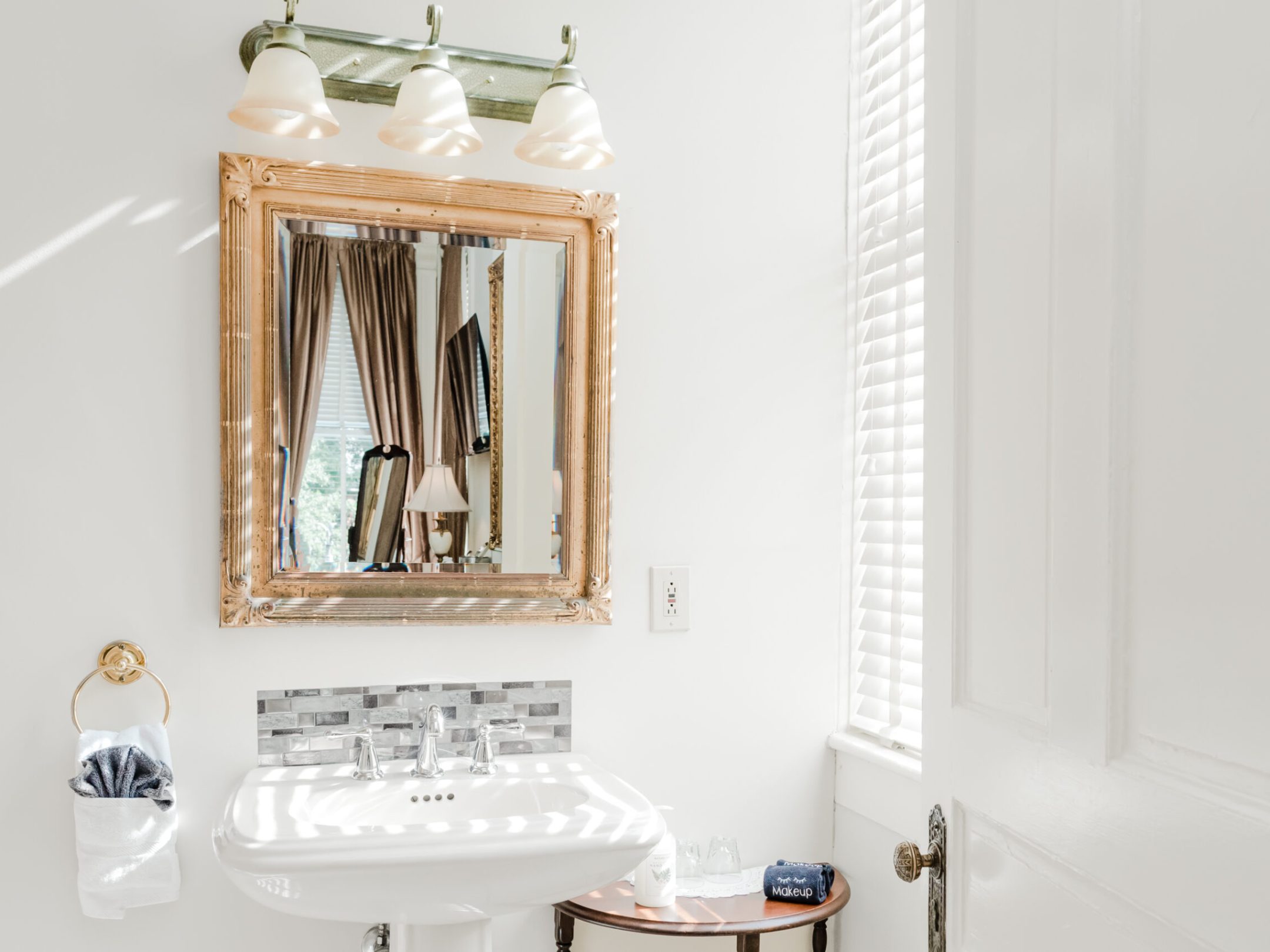 a room with a sink and a mirror