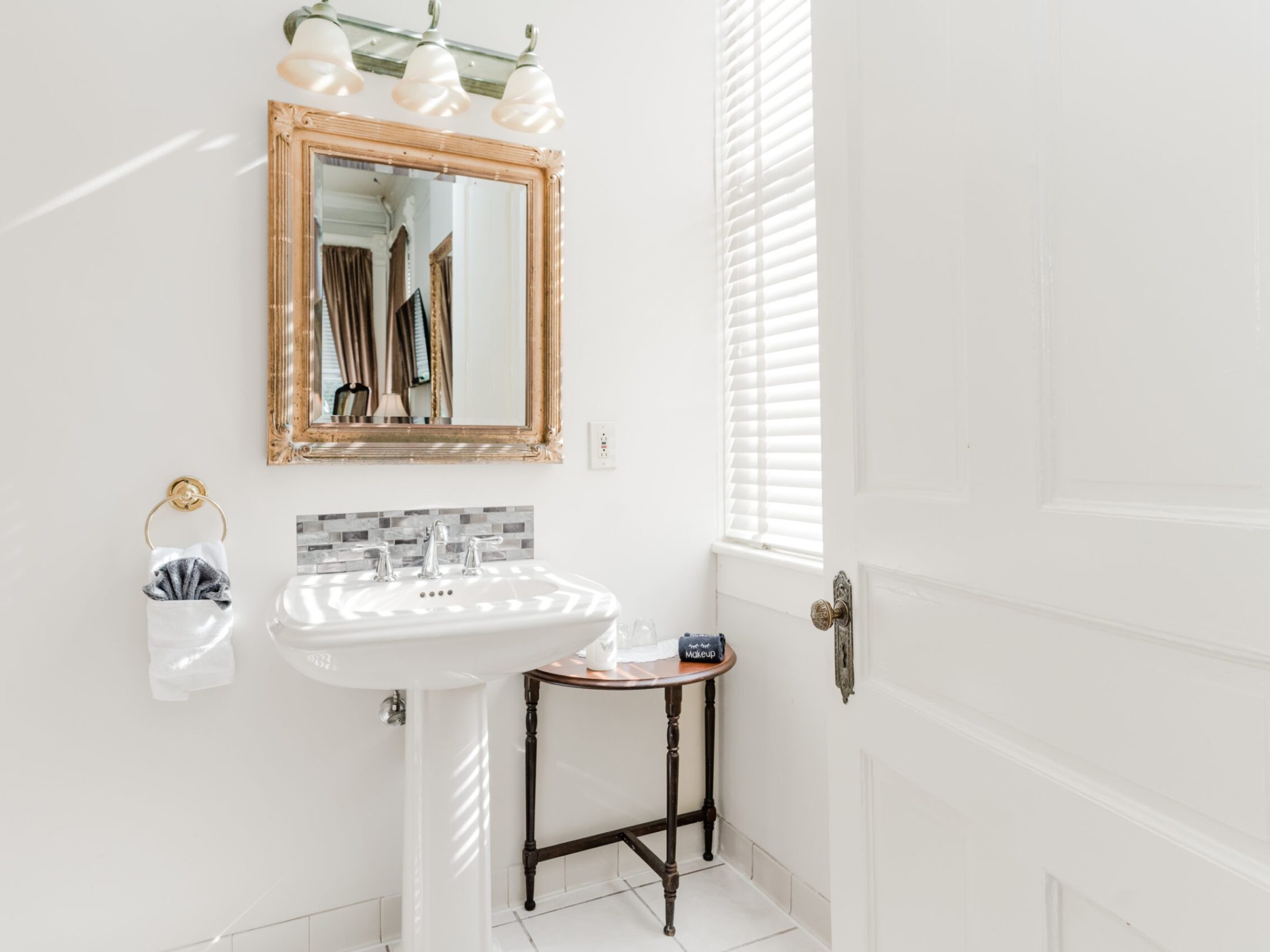 a room with a sink and a mirror