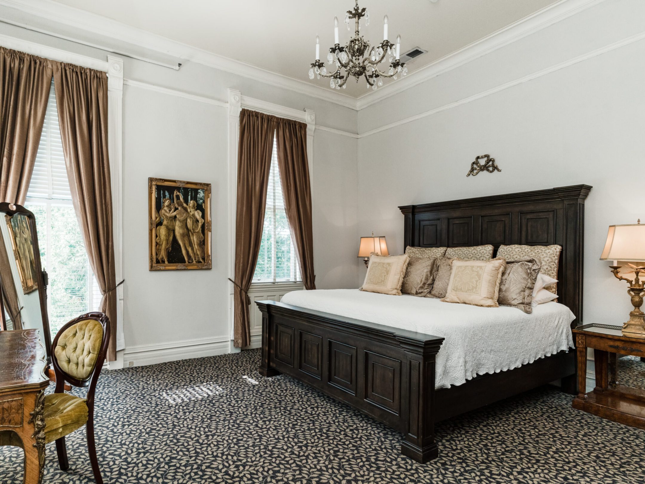 a bedroom with a bed and a chair in a room