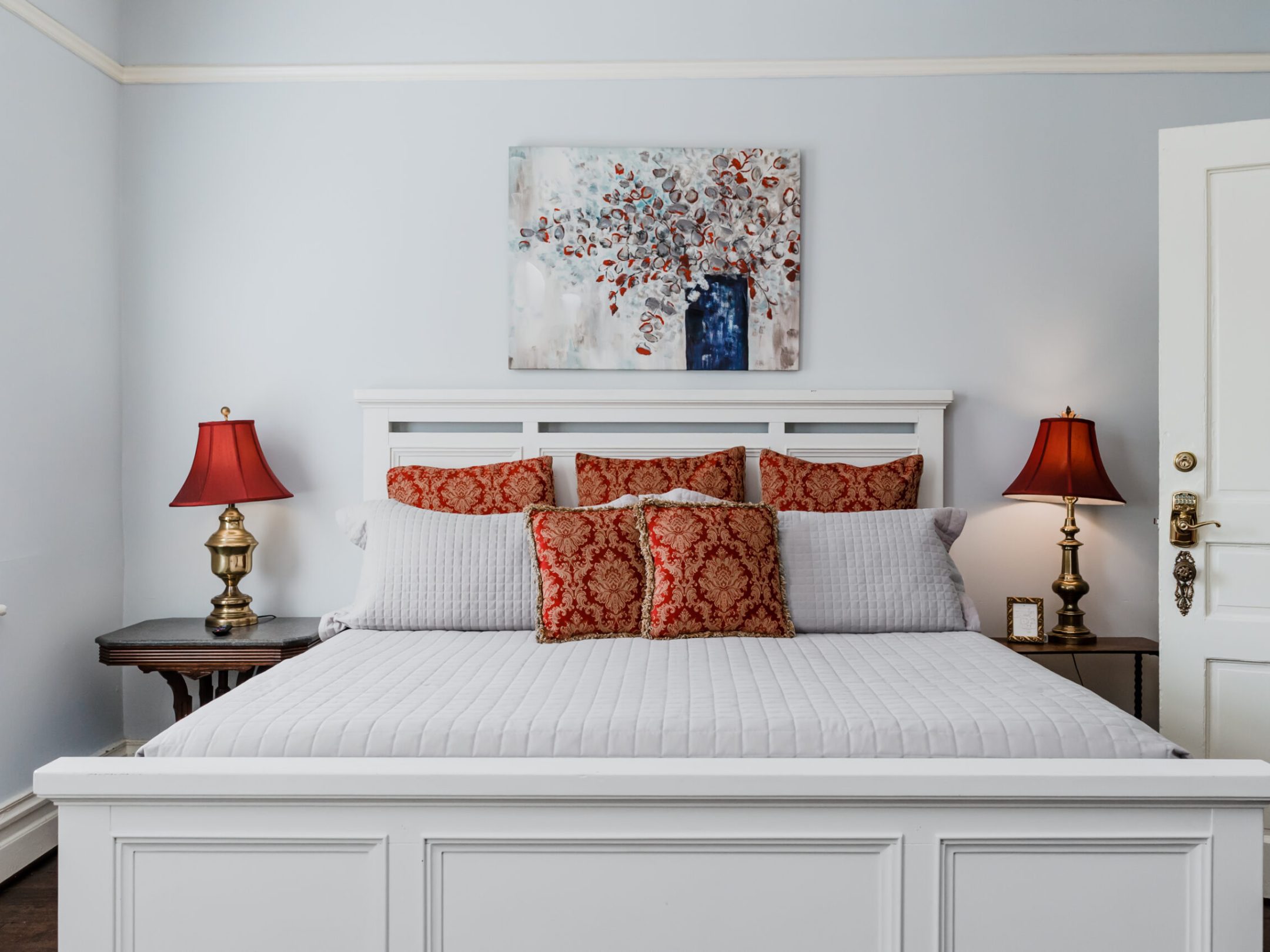 a bedroom with a bed and a mirror