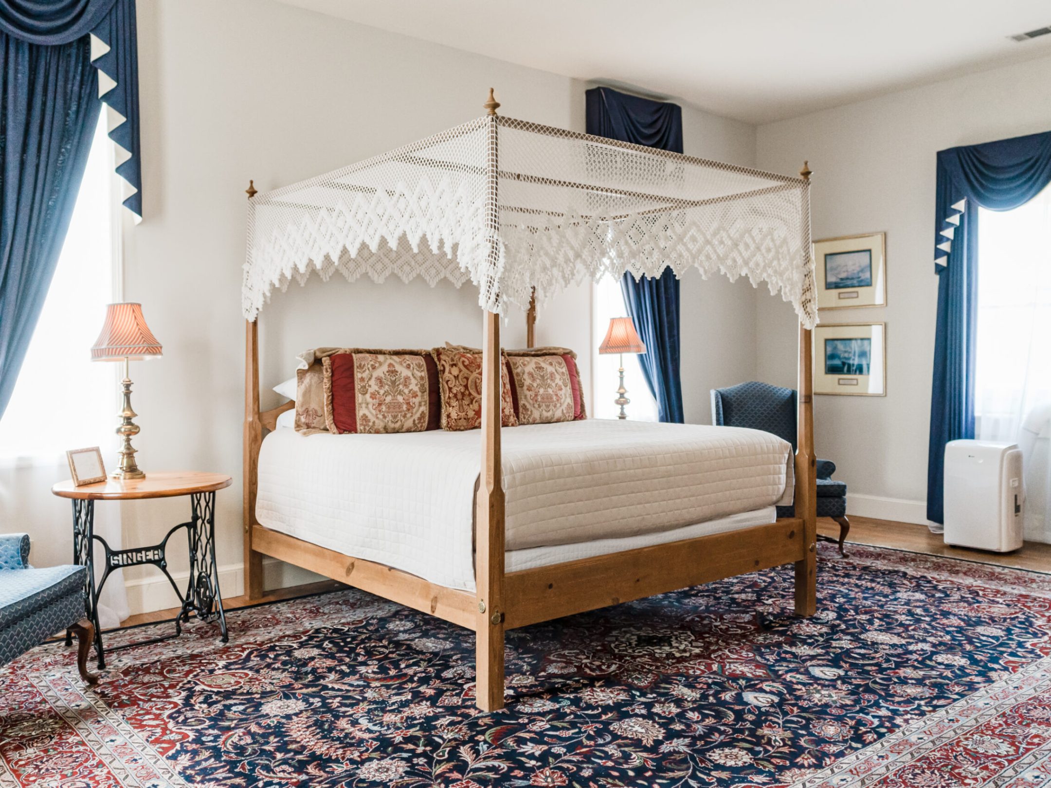 a bedroom with a bed and a chair in a room