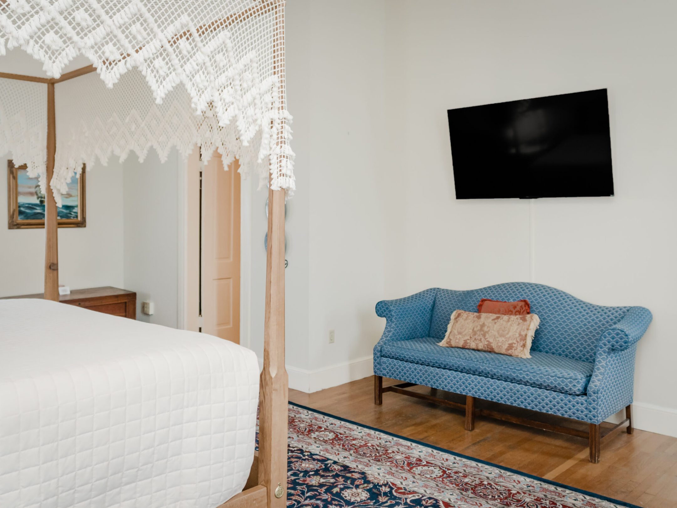 a bedroom with a bed and a chair in a room