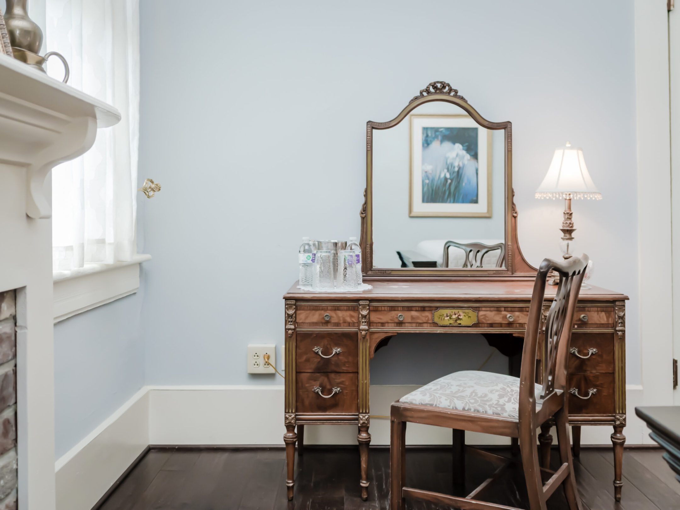 a bedroom with a bed and a chair in a room