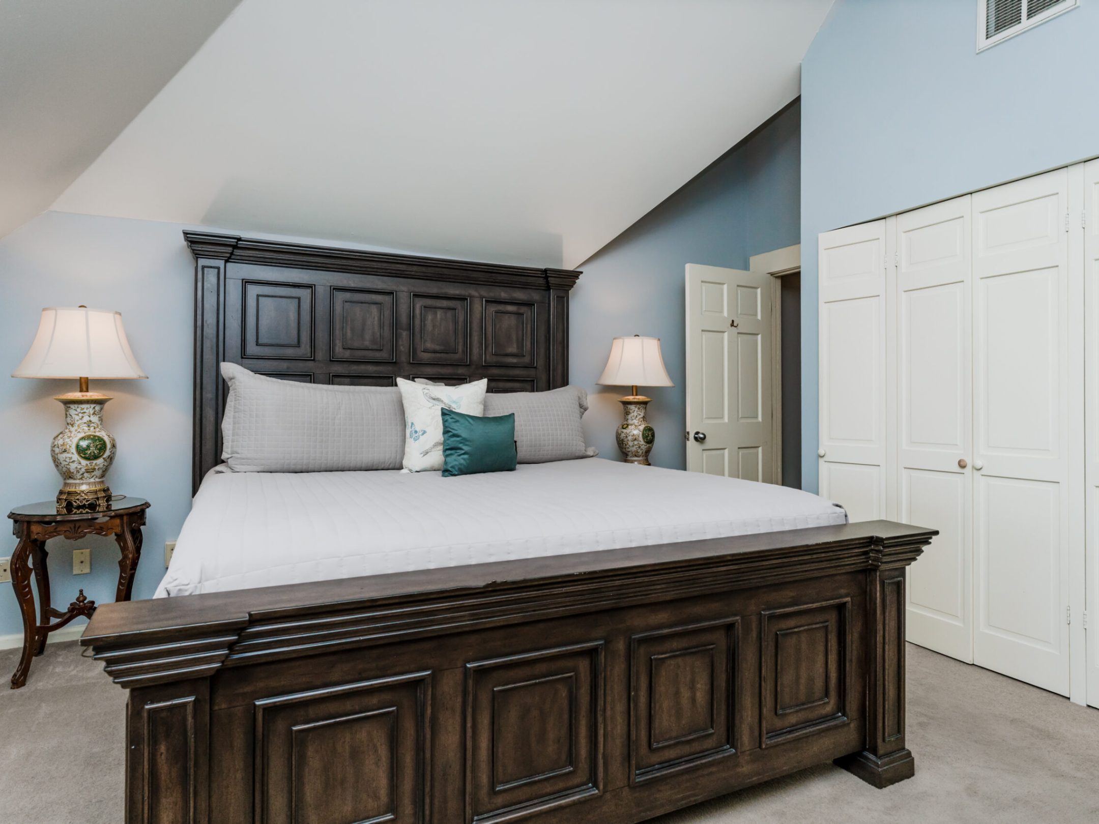 a bedroom with a bed and desk in a room