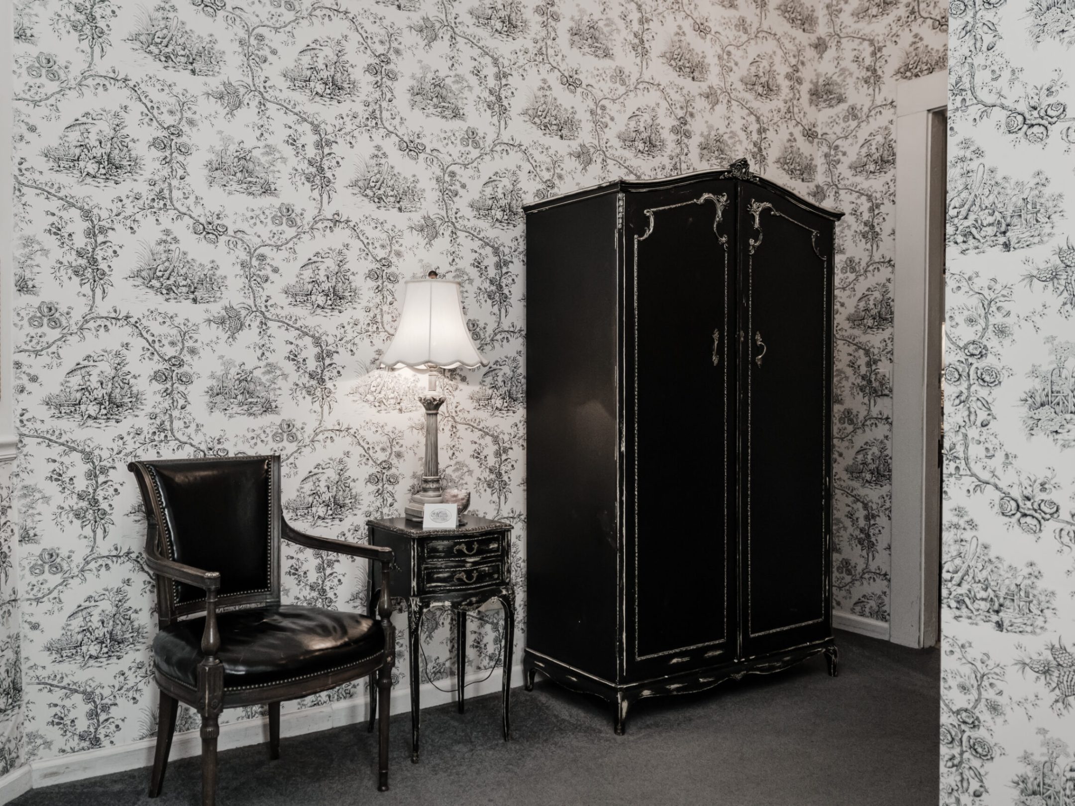 a bedroom with a bed and a chair in a room