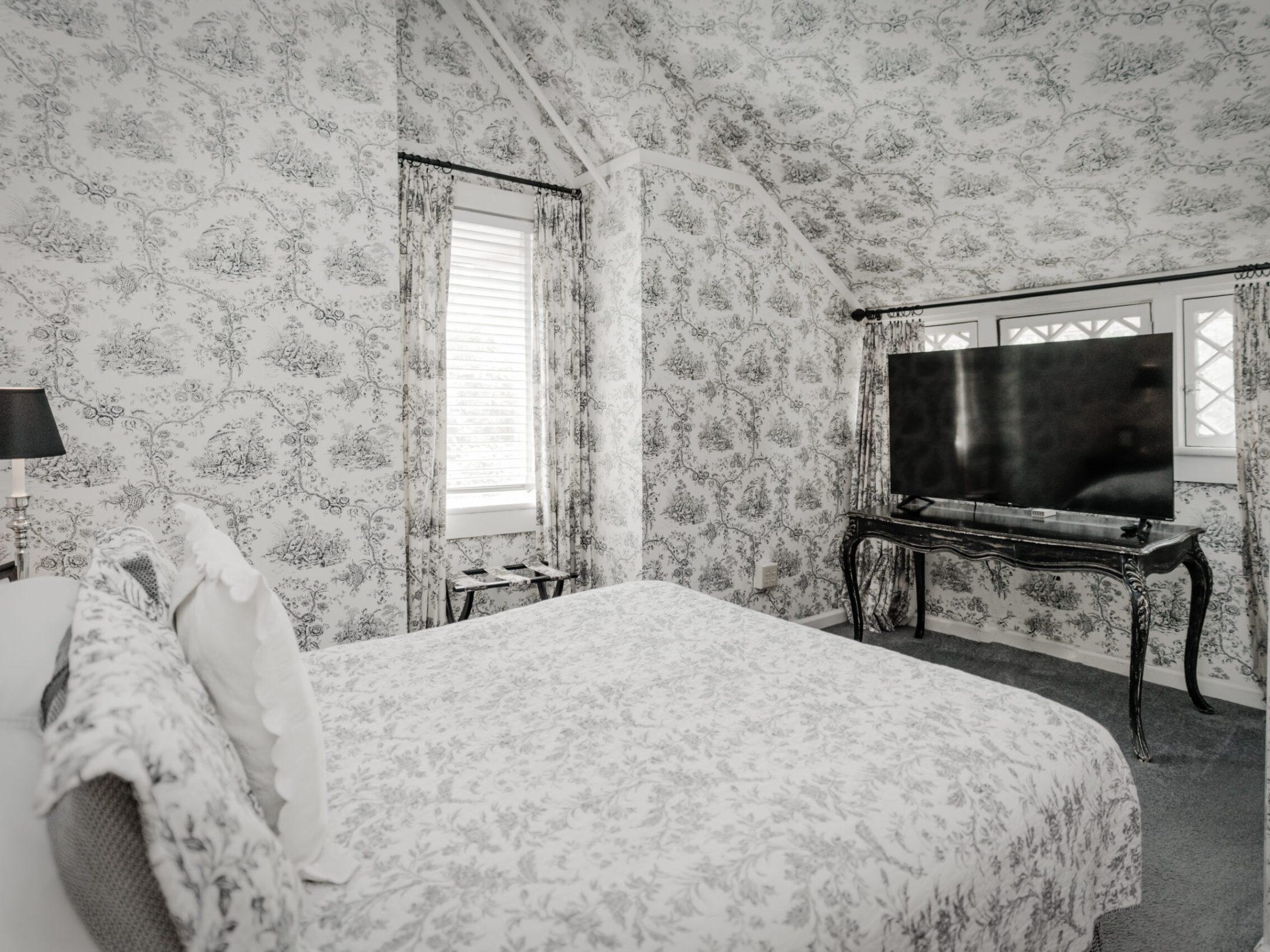 a bedroom with a bed in a room