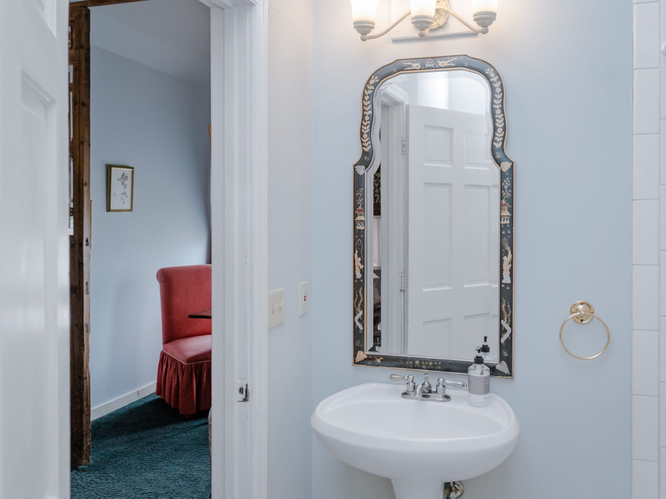 a room with a sink and a mirror