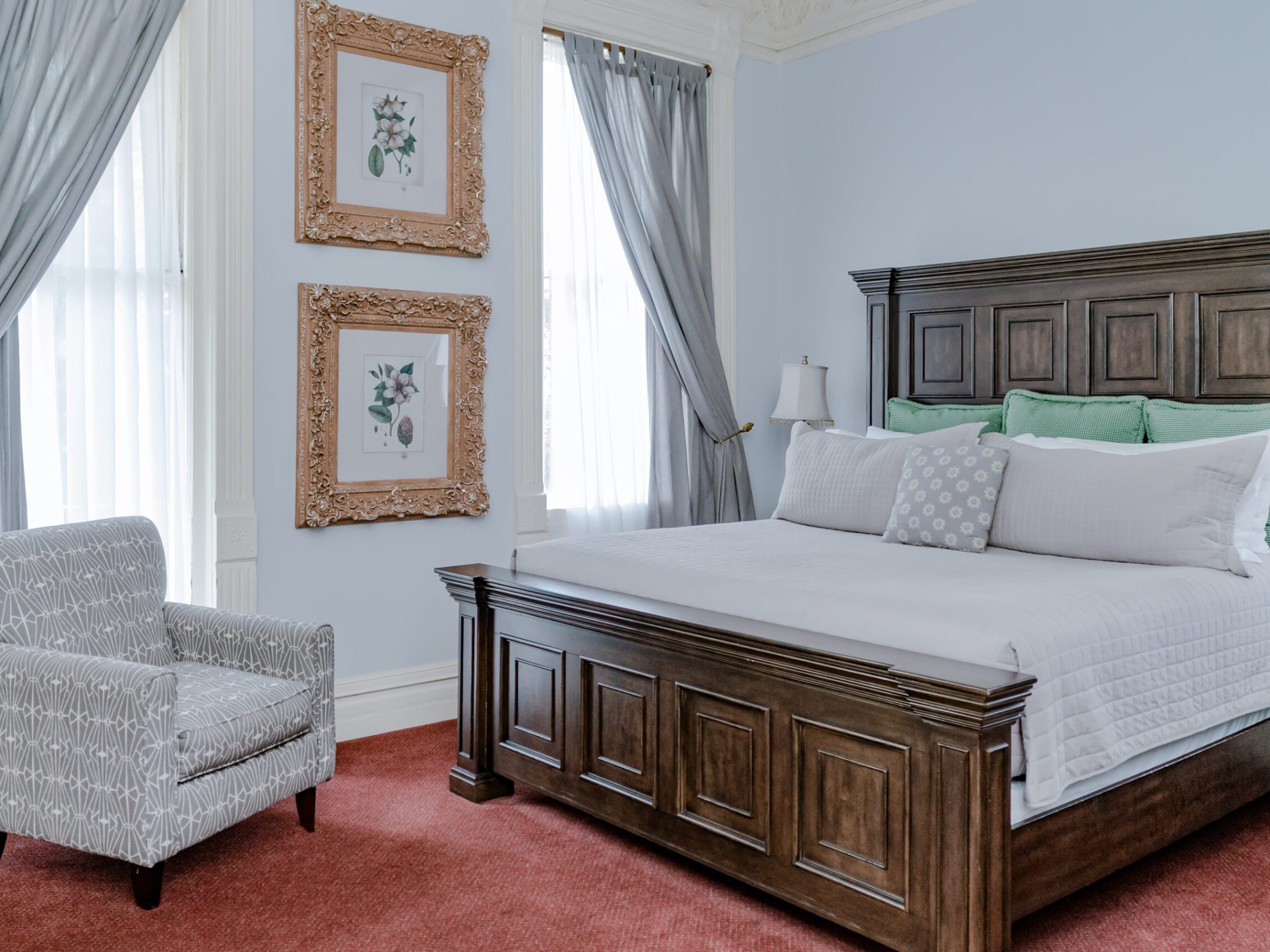 a bedroom with a bed and desk in a room