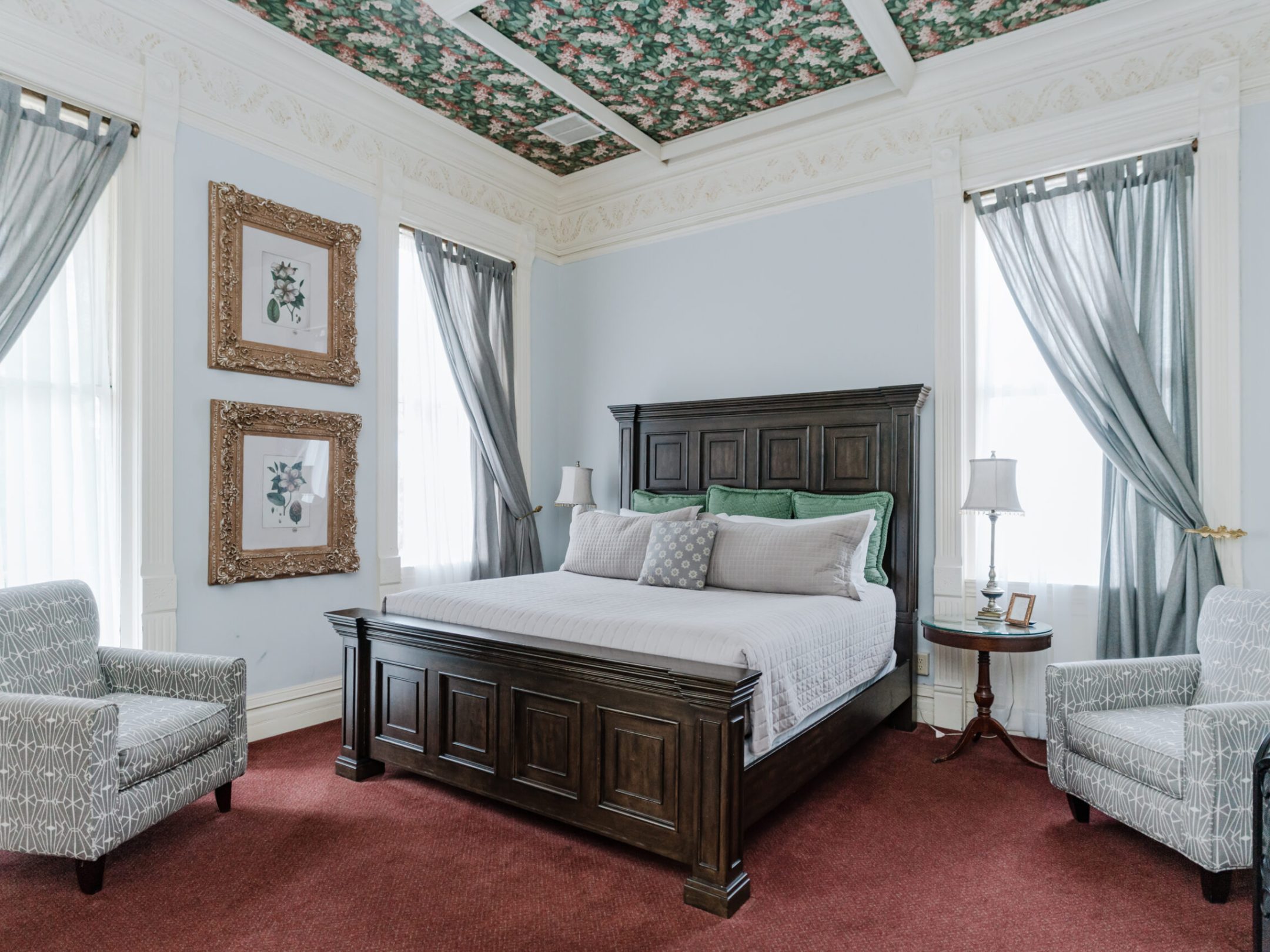 a bedroom with a bed and a chair in a room