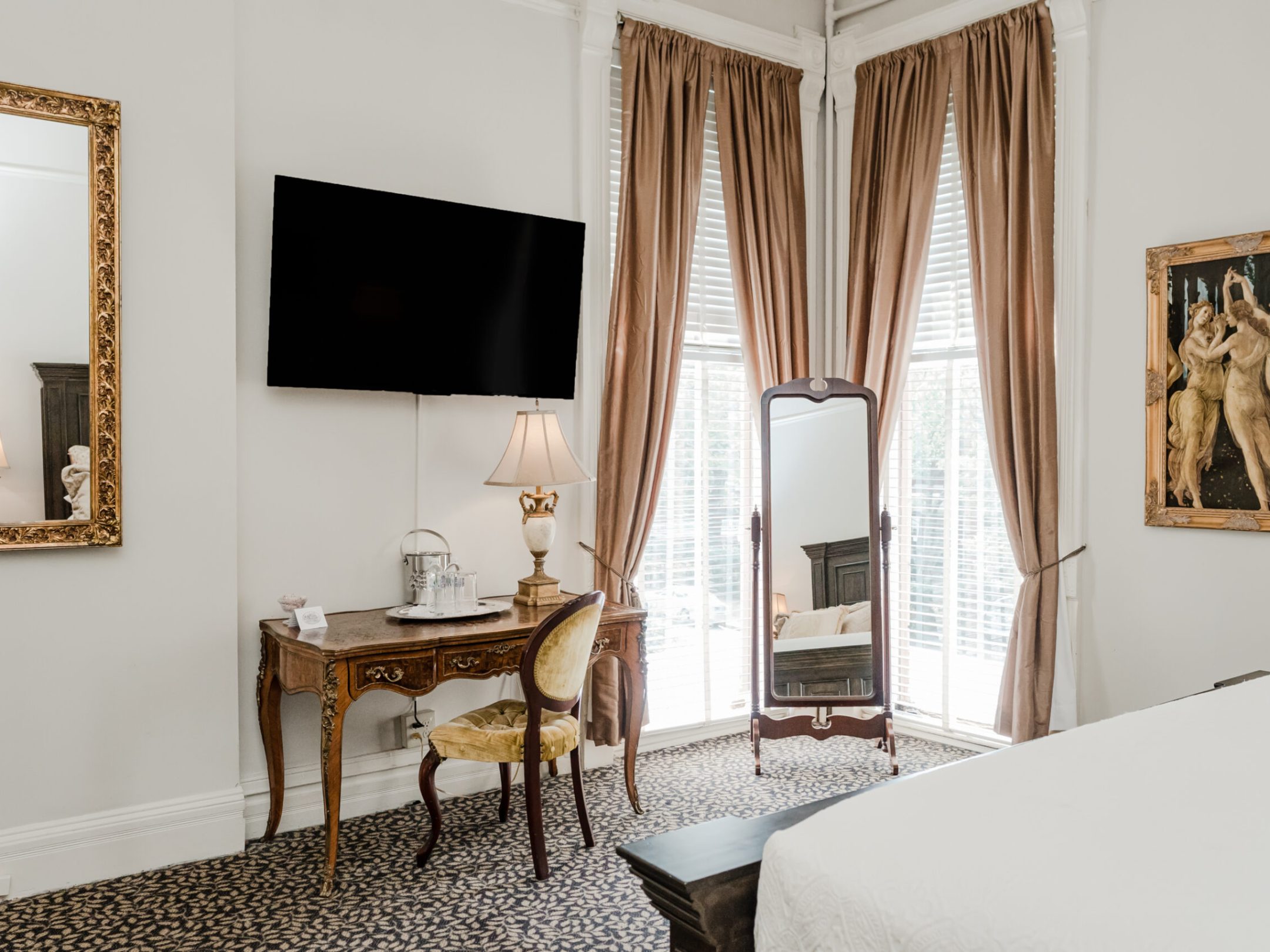 a bedroom with a bed and a chair in a room