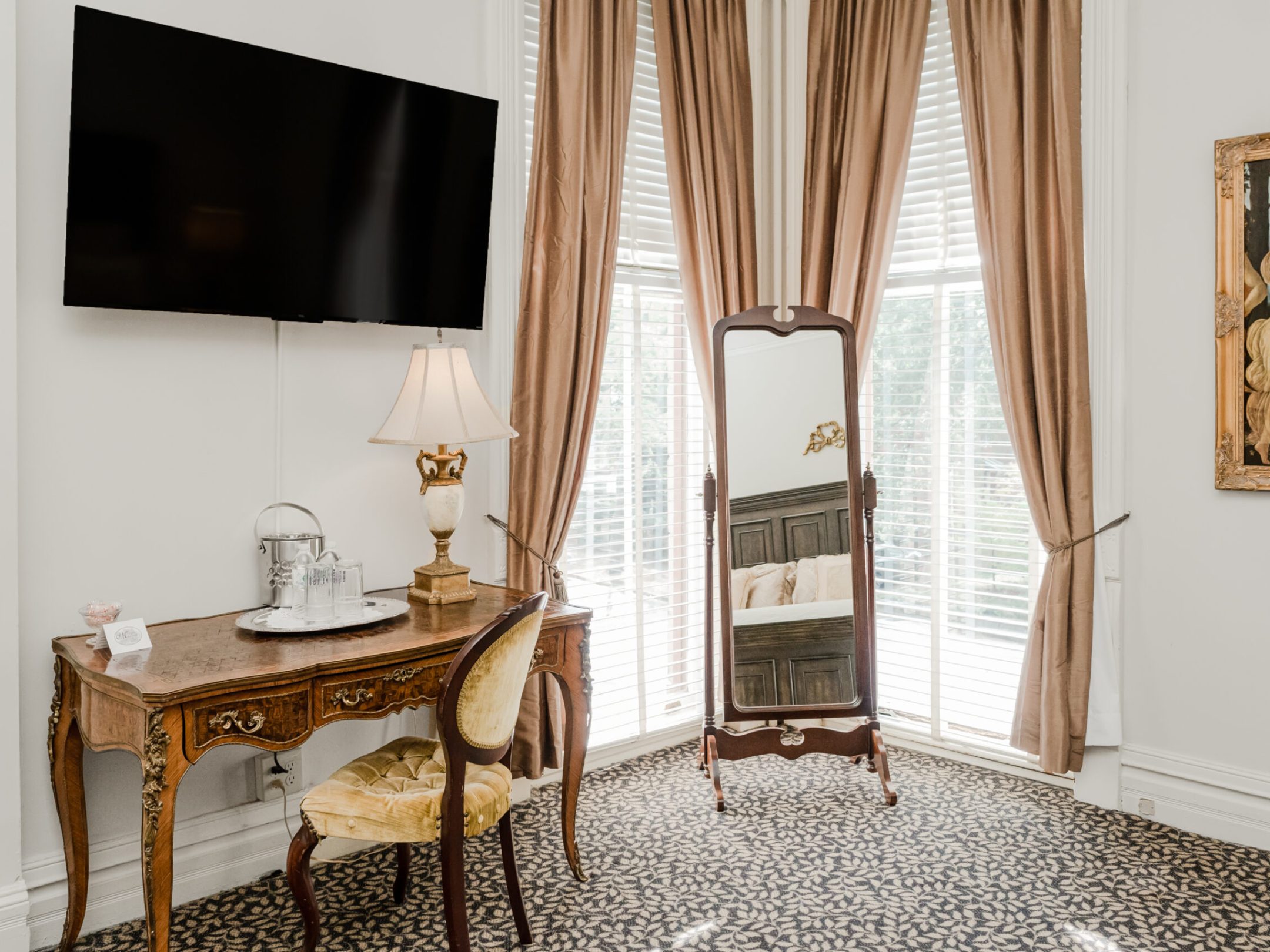 a bedroom with a bed and a chair in a room