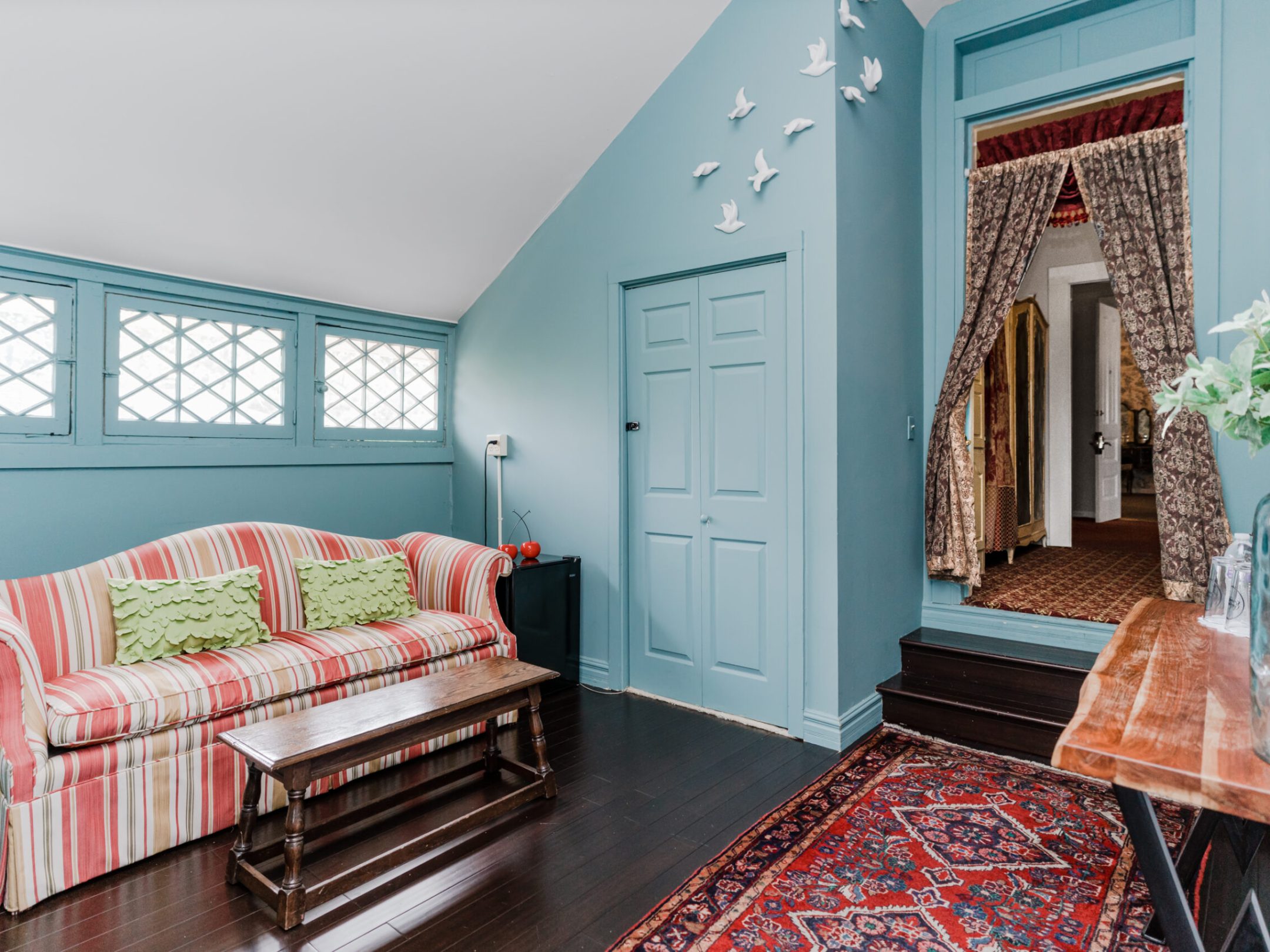 a living room filled with furniture and a large window