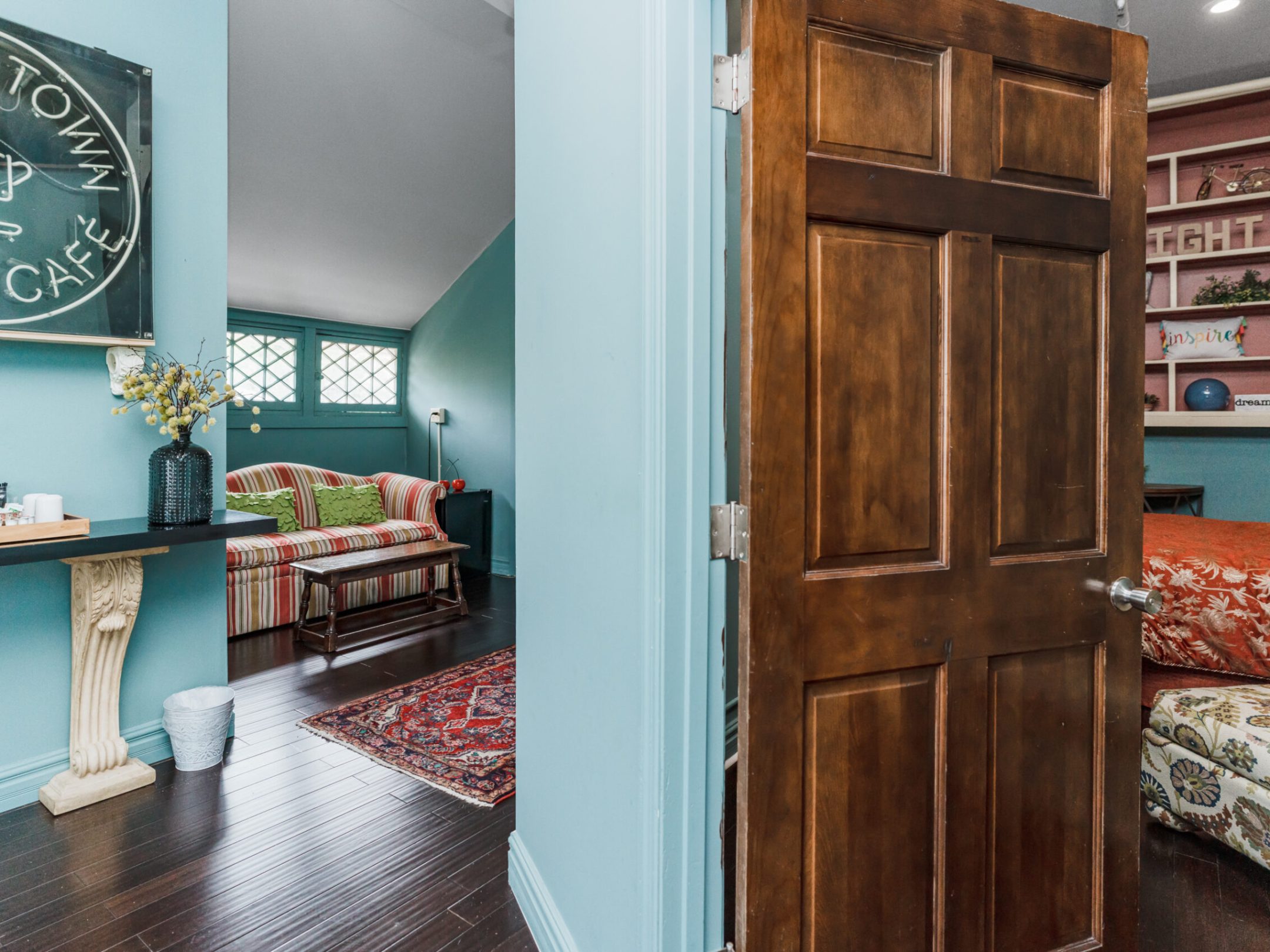 a bedroom with a bed and desk in a room