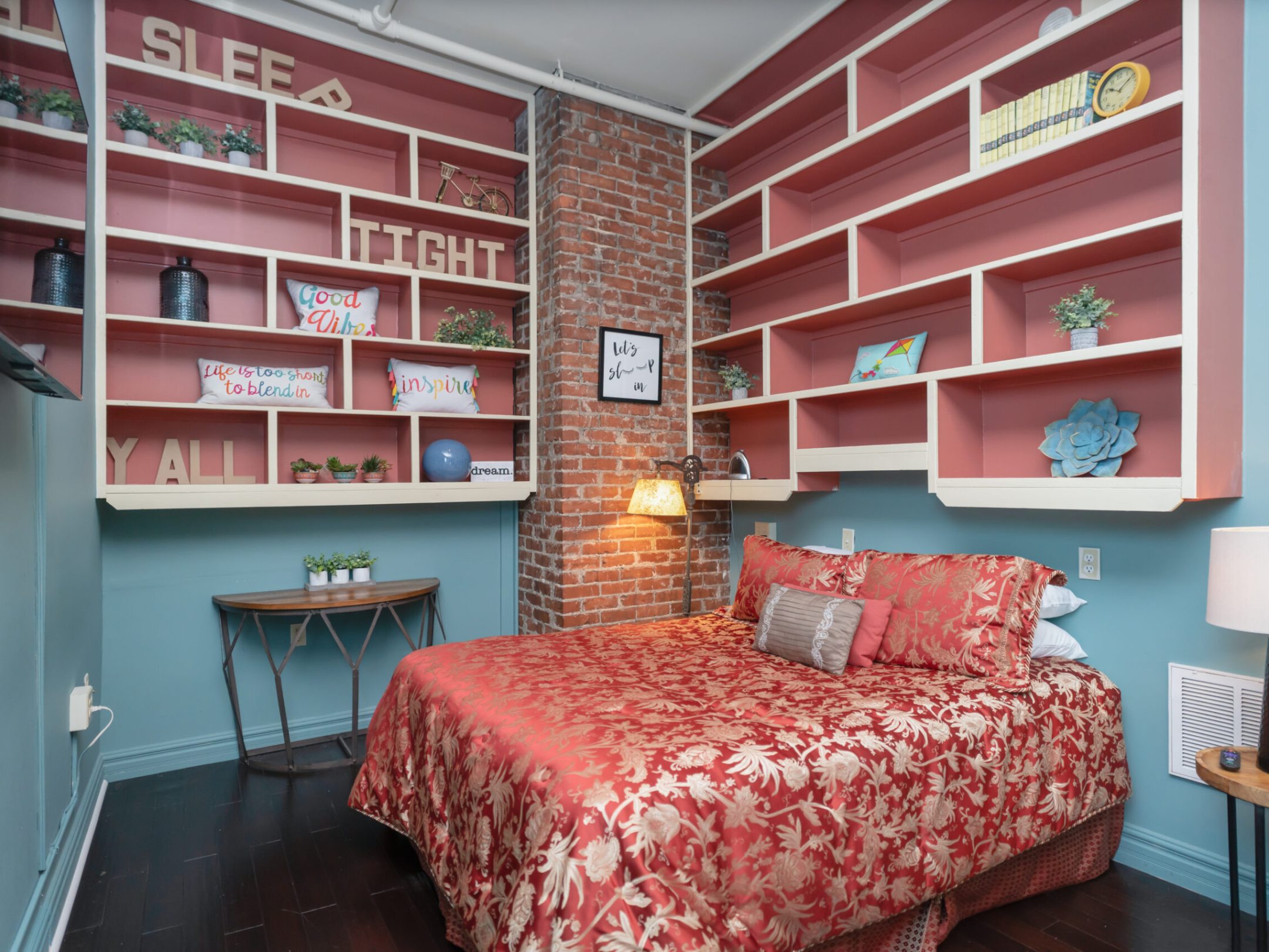 a bedroom with a bed and a chair in a room