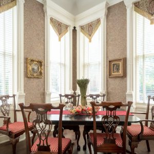 a dining room table in front of a window