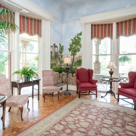 a living room filled with furniture and a fire place