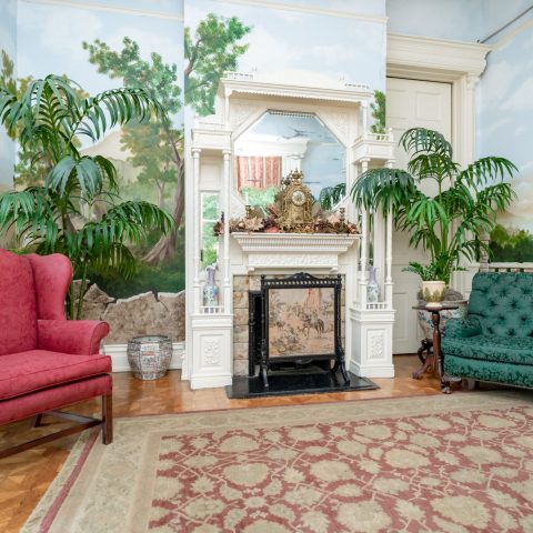 a living room filled with furniture and a large window