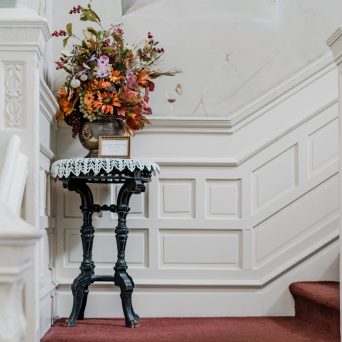 a vase of flowers sits in front of a window