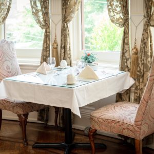 a room filled with furniture and vase of flowers on a table