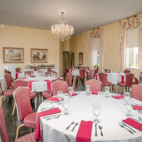 a living room filled with furniture and a fire place and a dining table