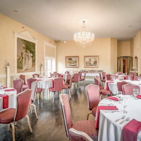 a bedroom with a bed and a chair in a room