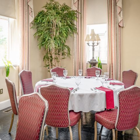 a dining room table in front of a window