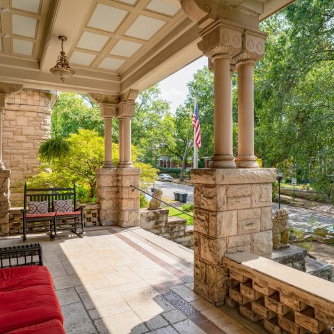 a person sitting on a bench next to a fireplace